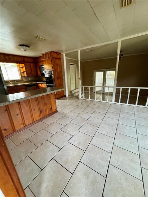 kitchen featuring light tile patterned floors and kitchen peninsula