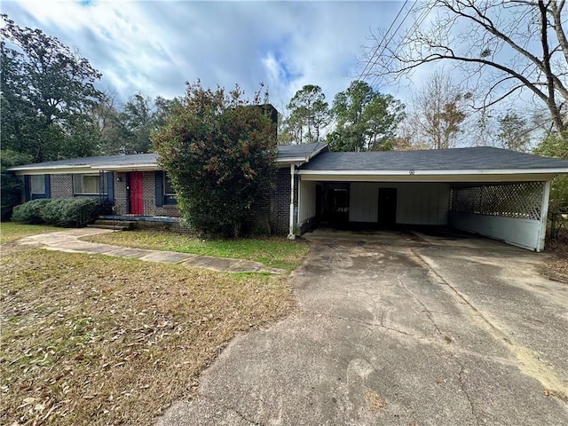 single story home featuring a carport