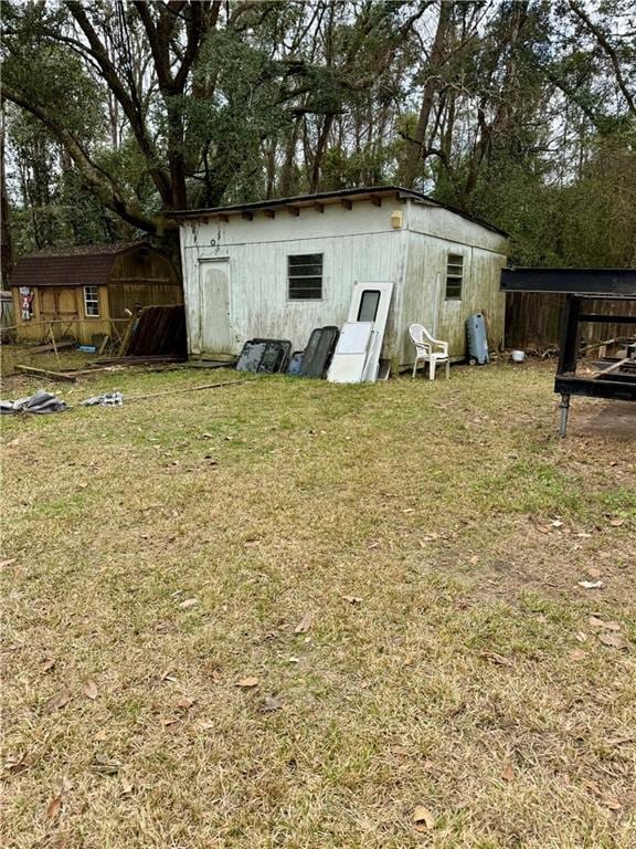 view of outdoor structure featuring a lawn