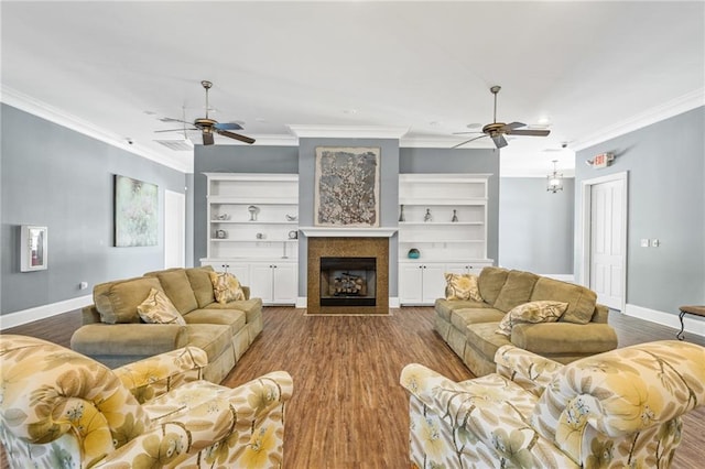 living room featuring ceiling fan, ornamental molding, hardwood / wood-style flooring, and built in shelves