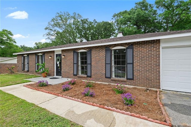 5717 Post Oak Ct, Mobile, AL 36609 - ranch-style house with brick siding, a garage, a chimney, and driveway