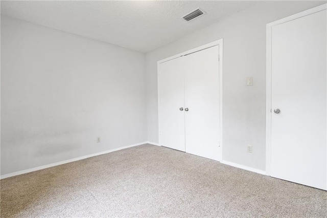 5717 Post Oak Ct, Mobile, AL 36609 - unfurnished bedroom featuring carpet floors, a closet, baseboards, and a textured ceiling