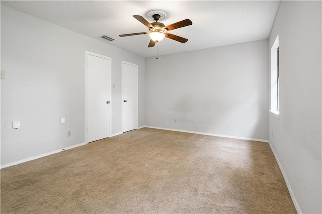5717 Post Oak Ct, Mobile, AL 36609 - unfurnished bedroom featuring carpet, baseboards, a ceiling fan, and multiple closets