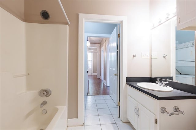 full bath featuring baseboards, vanity, tile patterned floors, and tub / shower combination