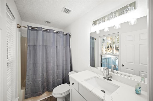 full bathroom with vanity, toilet, a textured ceiling, and shower / bath combo