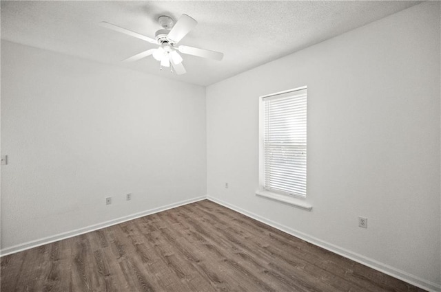 spare room with dark hardwood / wood-style floors, a textured ceiling, and ceiling fan