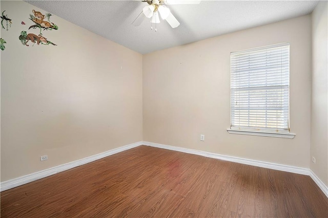 spare room featuring a textured ceiling, hardwood / wood-style flooring, and ceiling fan