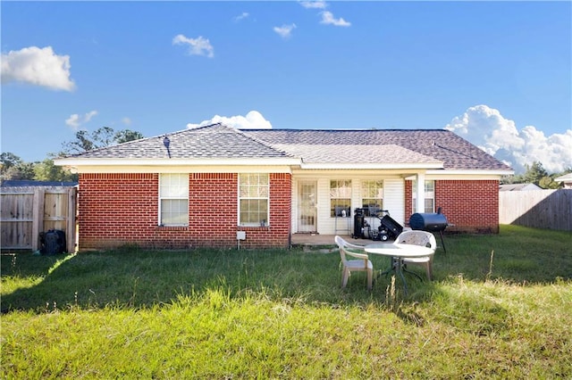 back of house featuring a yard