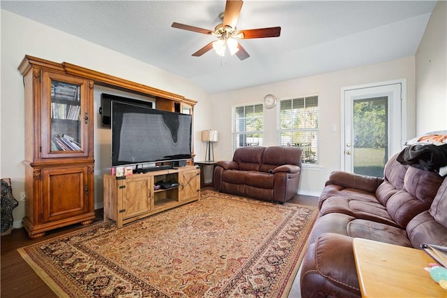 living room featuring ceiling fan, dark hardwood / wood-style flooring, and lofted ceiling