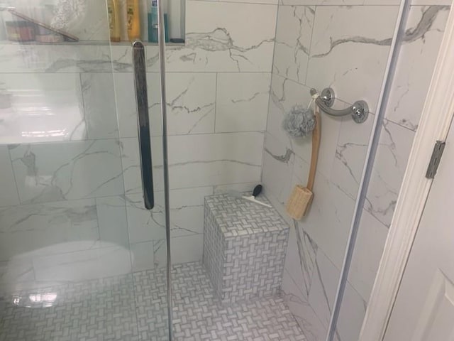 bathroom featuring a shower with shower door