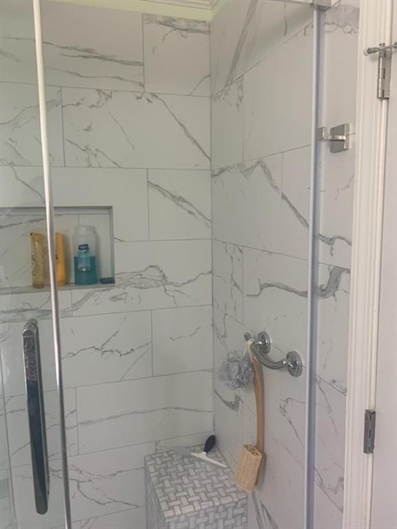 bathroom with tiled shower