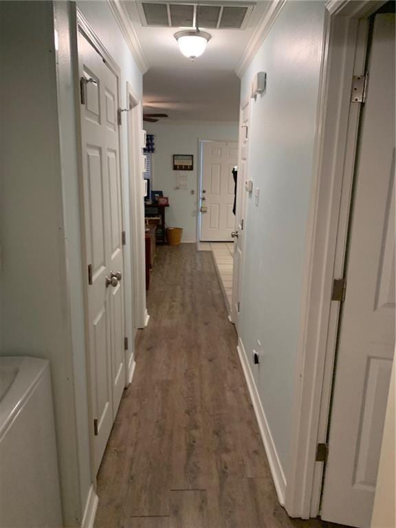 corridor featuring crown molding and dark wood-type flooring