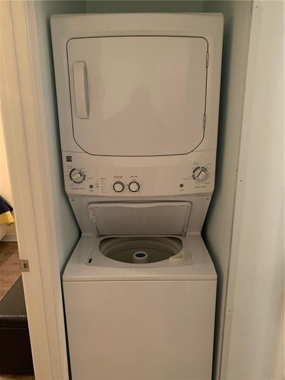 washroom featuring stacked washing maching and dryer