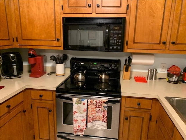 kitchen featuring sink and stainless steel range with electric cooktop