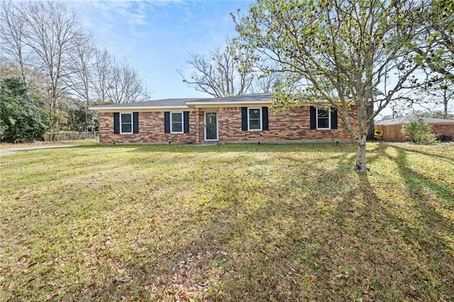 ranch-style house with brick siding, a front lawn, and fence