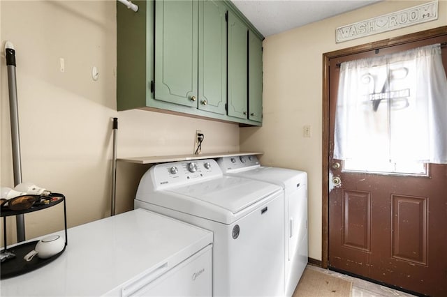 clothes washing area with cabinet space and separate washer and dryer