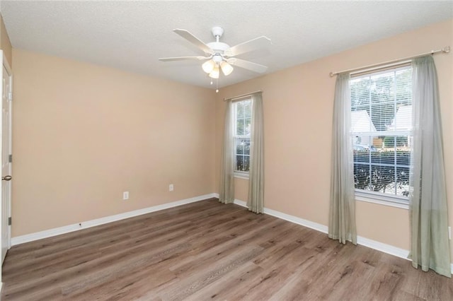 empty room featuring hardwood / wood-style floors and ceiling fan