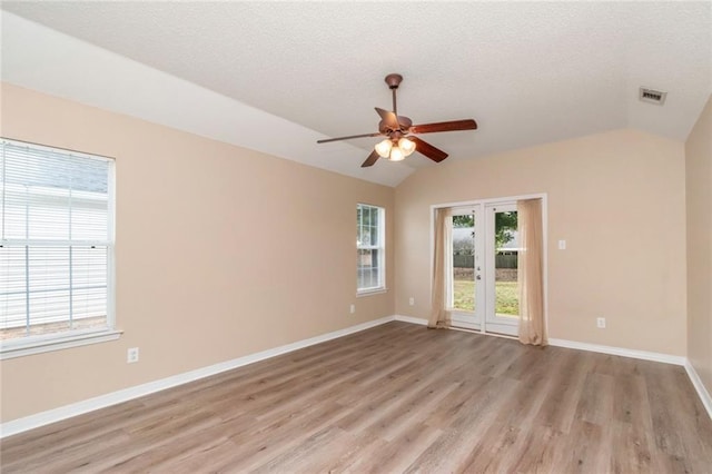 unfurnished room with lofted ceiling, light hardwood / wood-style floors, french doors, and ceiling fan