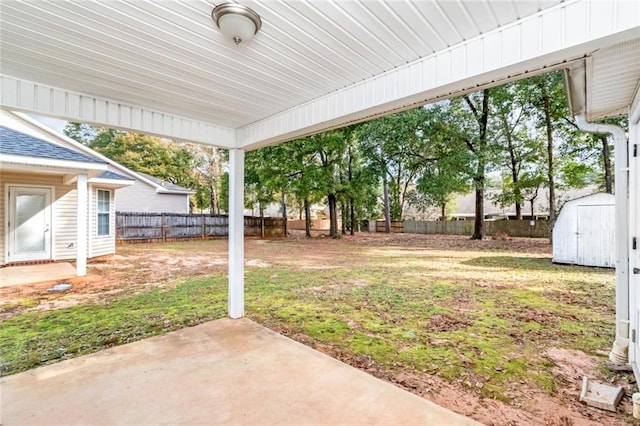 view of yard with a shed and a patio area