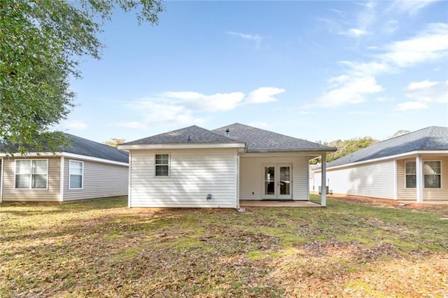 back of property featuring a yard