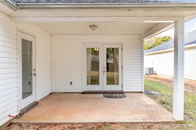 view of exterior entry with a patio area and french doors