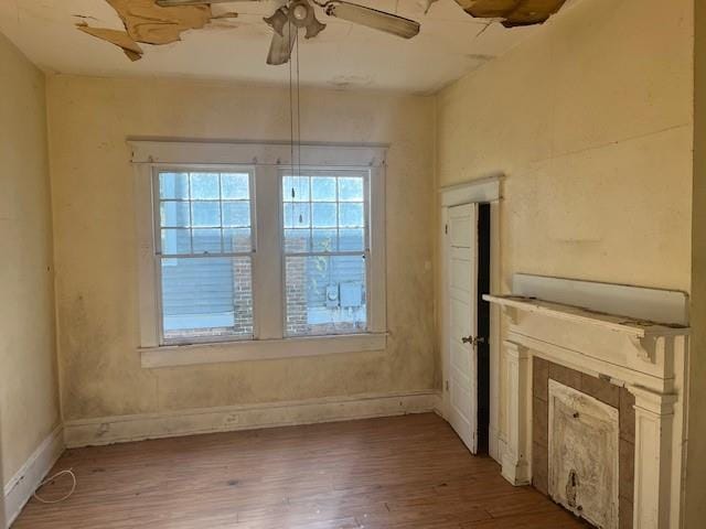 unfurnished dining area with ceiling fan and hardwood / wood-style flooring