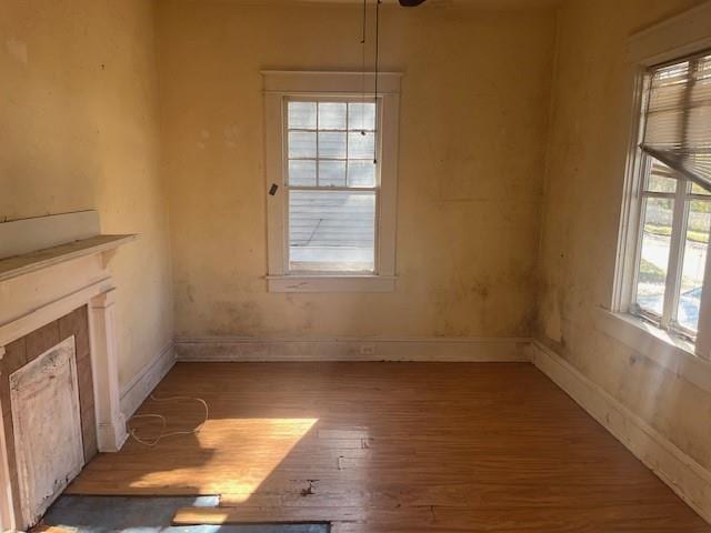 interior space featuring hardwood / wood-style floors and a tiled fireplace