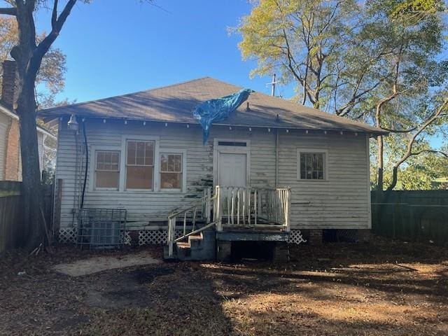 back of property featuring central AC unit