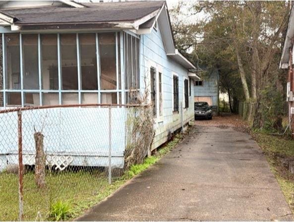 view of side of home with a sunroom