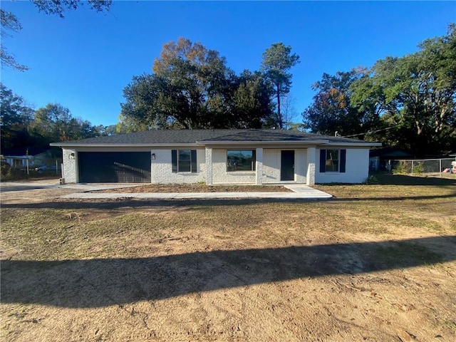 ranch-style home with a front yard and a garage