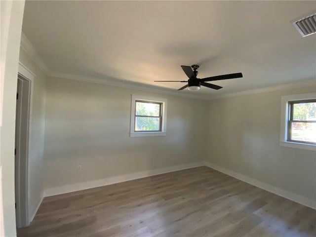 empty room with ceiling fan, ornamental molding, and hardwood / wood-style flooring