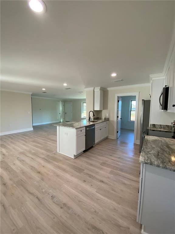 kitchen with stainless steel dishwasher, stove, white cabinetry, and kitchen peninsula