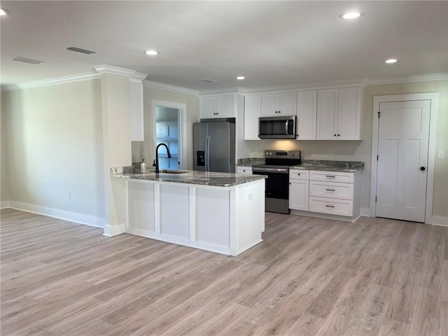 kitchen featuring kitchen peninsula, white cabinetry, light wood-type flooring, and appliances with stainless steel finishes