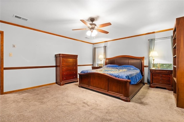 carpeted bedroom featuring ceiling fan and ornamental molding