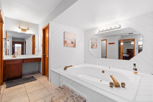 bathroom featuring a tub to relax in, vanity, and tile patterned flooring