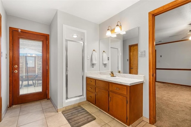 bathroom featuring ceiling fan, vanity, tile patterned flooring, and walk in shower