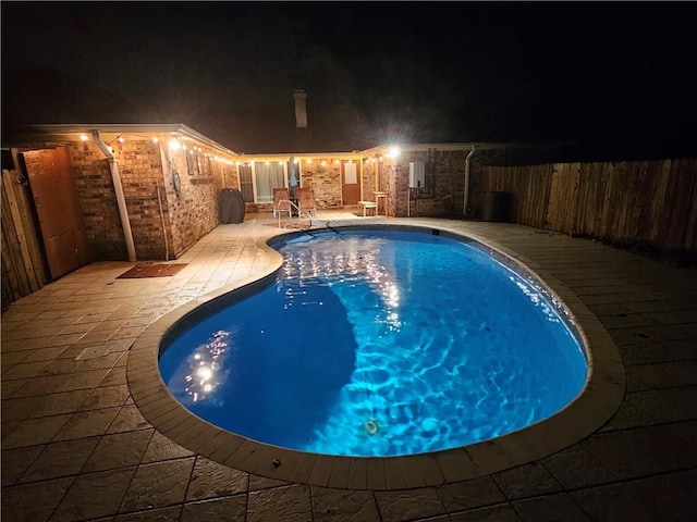 pool at night with a patio