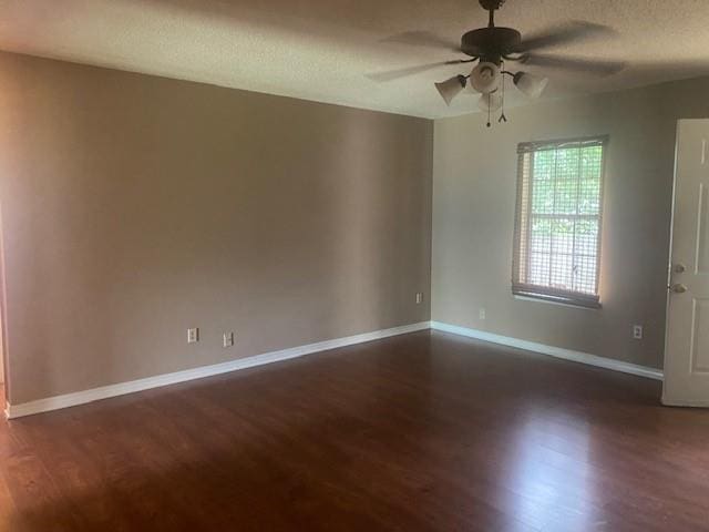 unfurnished room with ceiling fan, dark hardwood / wood-style flooring, and a textured ceiling