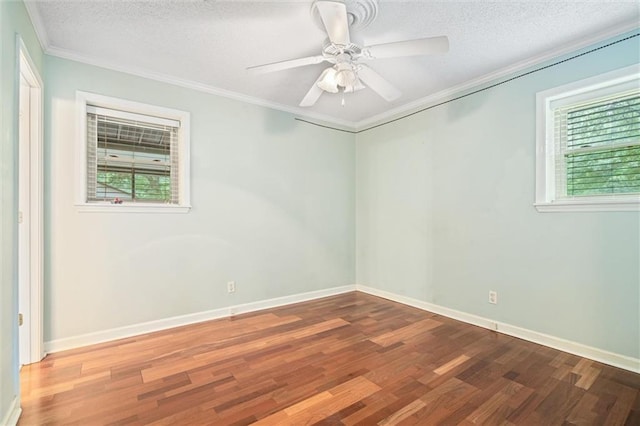 unfurnished room featuring ceiling fan, wood-type flooring, and a healthy amount of sunlight