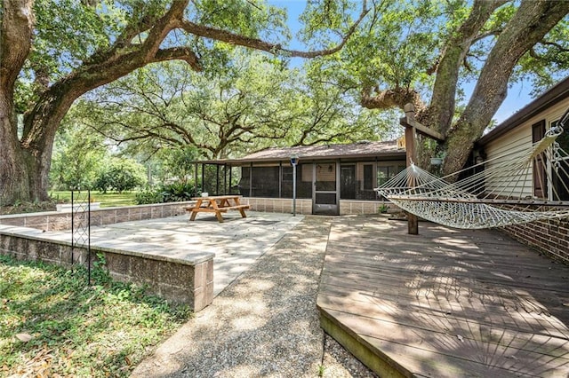 exterior space with a sunroom and a wooden deck