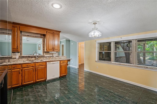 kitchen featuring a textured ceiling, dishwasher, sink, dark tile patterned flooring, and decorative light fixtures