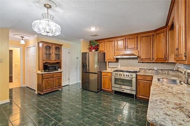 kitchen featuring dark tile patterned flooring, stainless steel appliances, sink, ornamental molding, and decorative backsplash