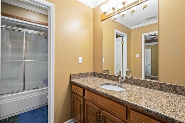 bathroom with enclosed tub / shower combo, crown molding, vanity, and tile patterned flooring