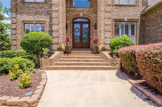 property entrance with french doors and brick siding