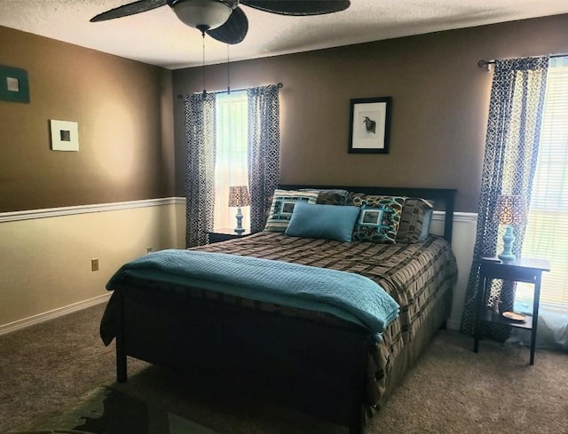 carpeted bedroom with ceiling fan and a textured ceiling