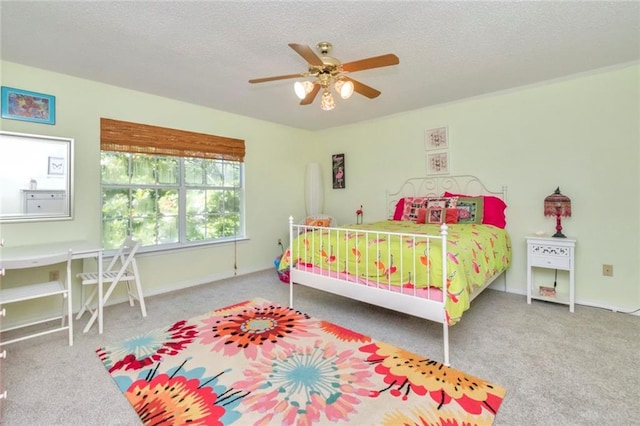 carpeted bedroom with ceiling fan and a textured ceiling