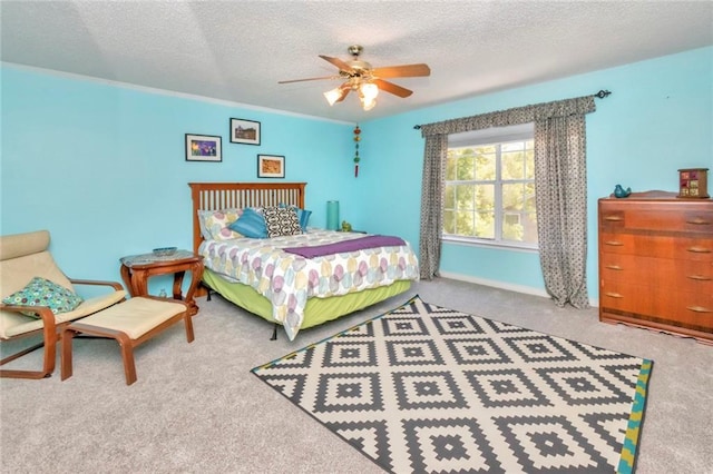 bedroom with ceiling fan, carpet floors, and a textured ceiling