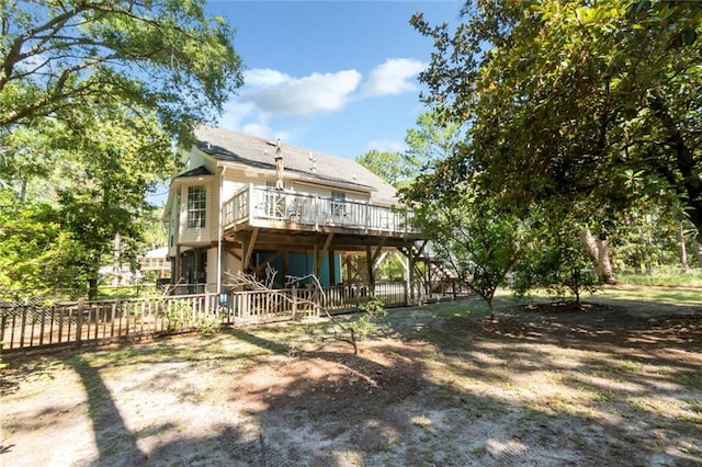 rear view of house featuring a wooden deck