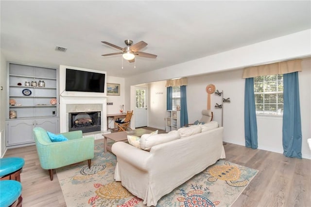 living room with light wood-type flooring and ceiling fan