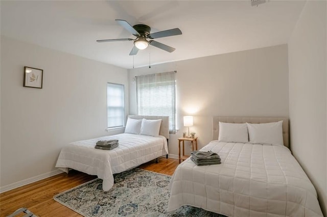 bedroom with ceiling fan and wood-type flooring